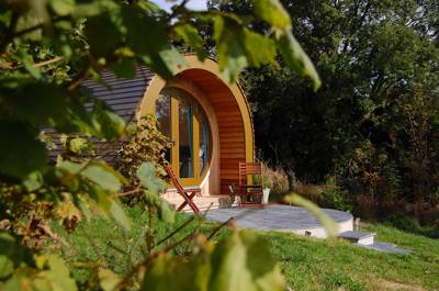 A single, cedar-clad luxury glamping pod in Ceredigion with stunning views over a Welsh valley and acres of private space.