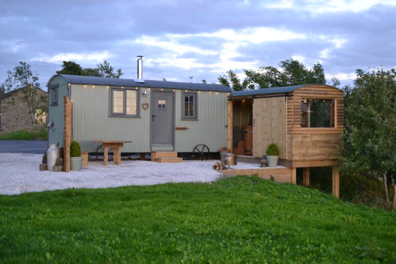The two shepherd&#39;s huts each have an adjoining log cabin.