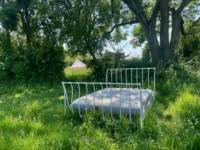 5m Bell tent with outdoor bed under a tree